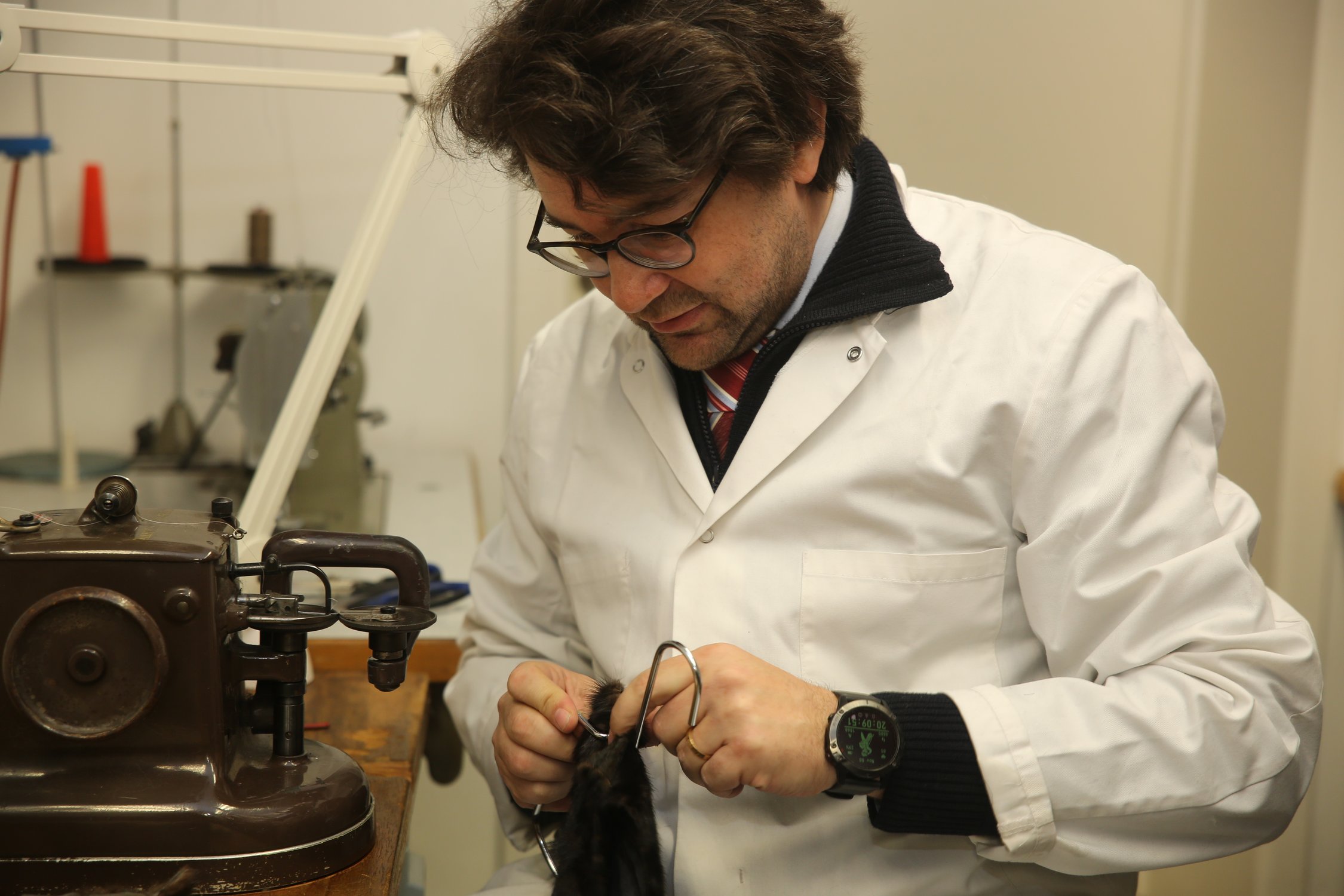 Lionel at the furrier's sewing machine, in concentration