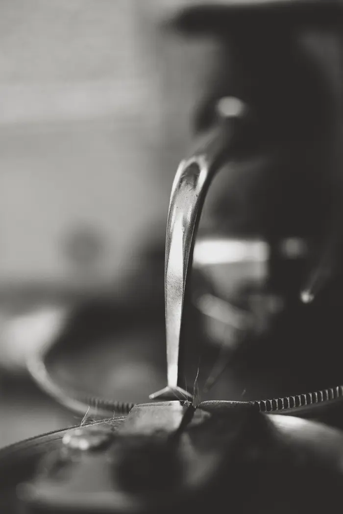 Close-up of a furrier's sewing machine, in black and white